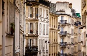 balcony view down a Paris street corridor
