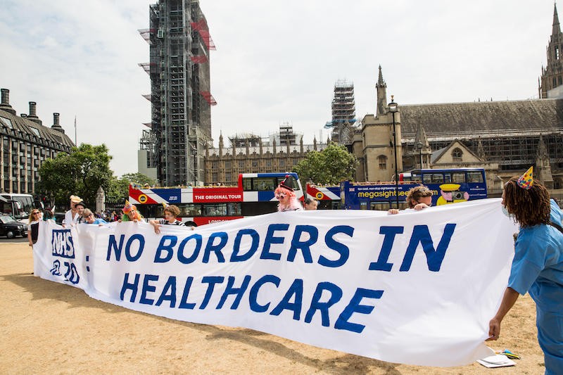 Students holding banner: No Borders in Healthcare