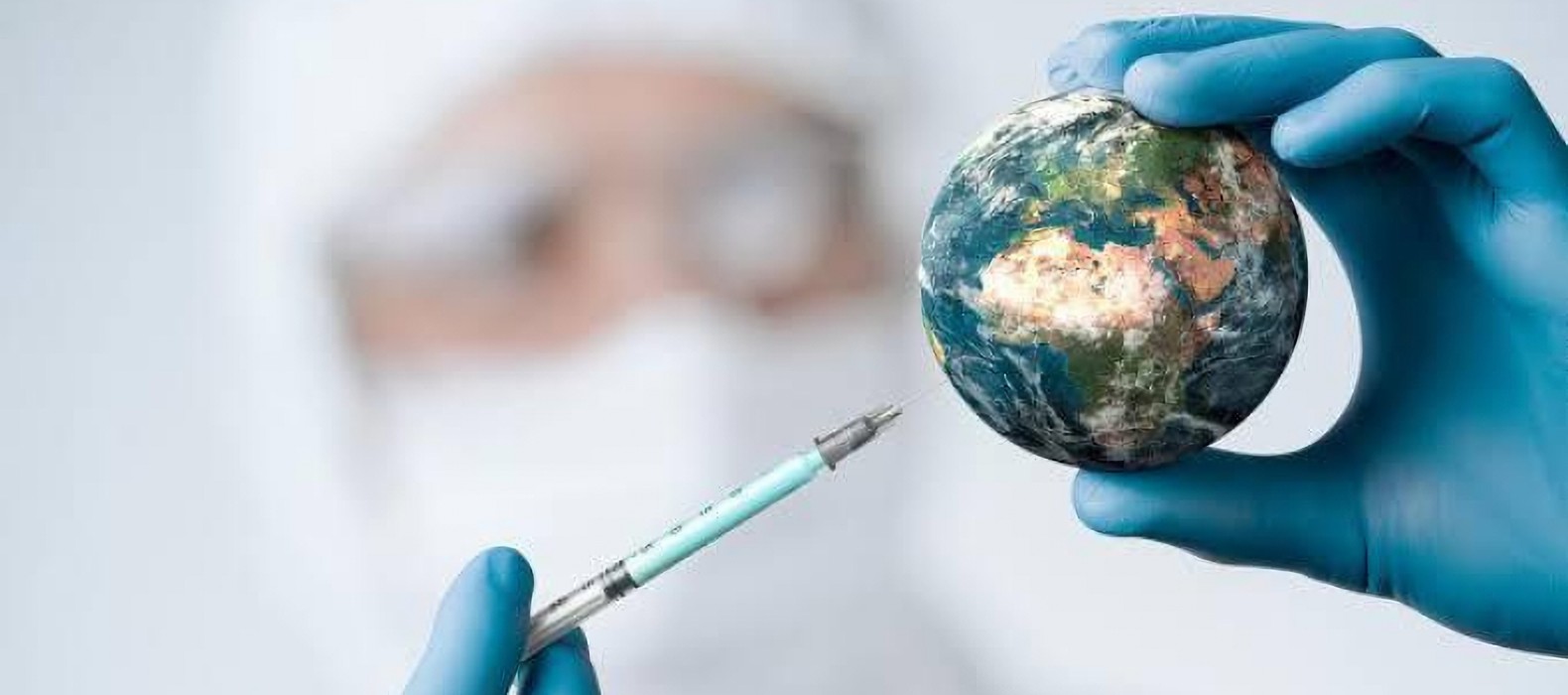 person using a syringe on a small model of the earth