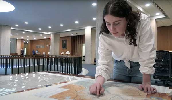 Ronak Elias with a map of Iraq woman studies map
