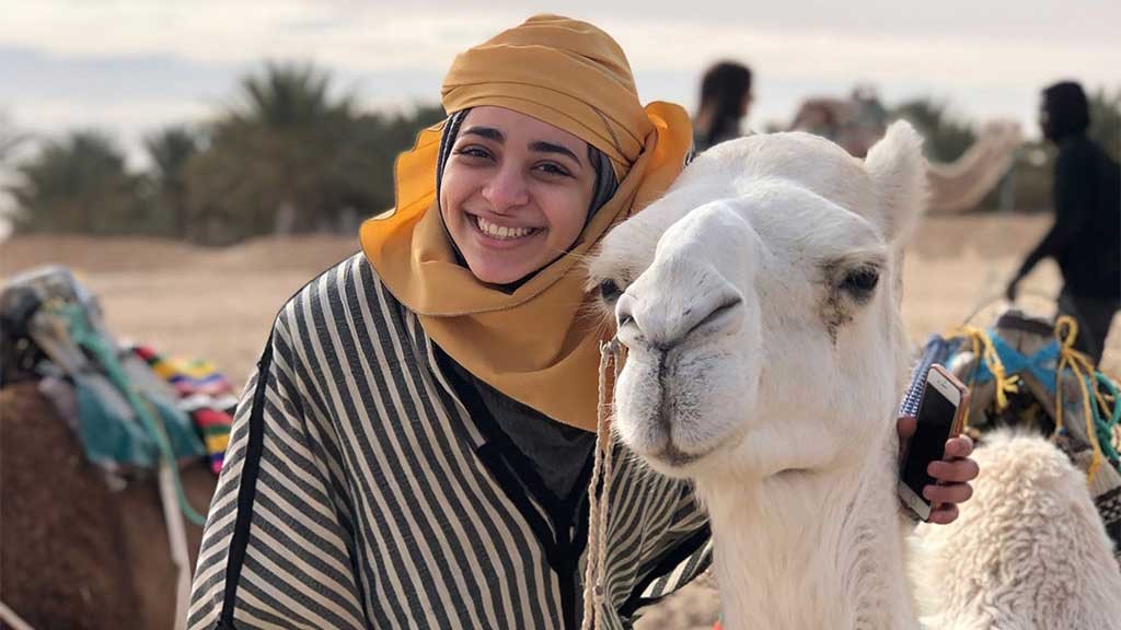 smiling woman with camel