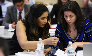 two students reviewing documents at a workshop in Rio de Janeiro