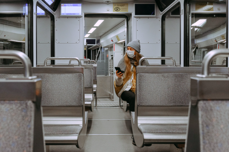 Woman with face mask on public transport.