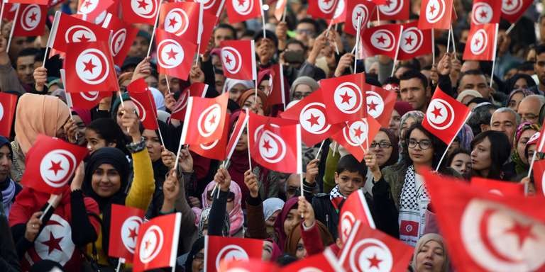 Crowd waving Tunisian flag