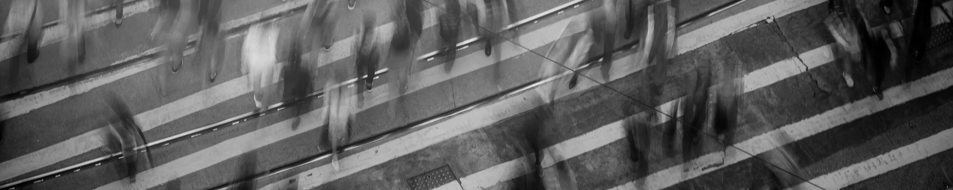 Blurred image of people moving in crosswalk. Pexels photo by Mike Chai.