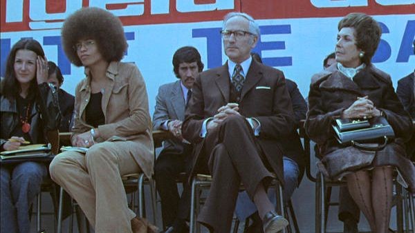 Angela Davis, Enrique Kirberg, and First Lady of Chile Hortensia Bussi at UTE in 1972. Source: “Angela Davis en la UTE (1972),” Archivo Patrimonial USACH. Angela Davis, Enrique Kirberg, and First Lady of Chile Hortensia Bussi at UTE in 1972. Source: “Angela Davis en la UTE (1972),” Archivo Patrimonial USACH.