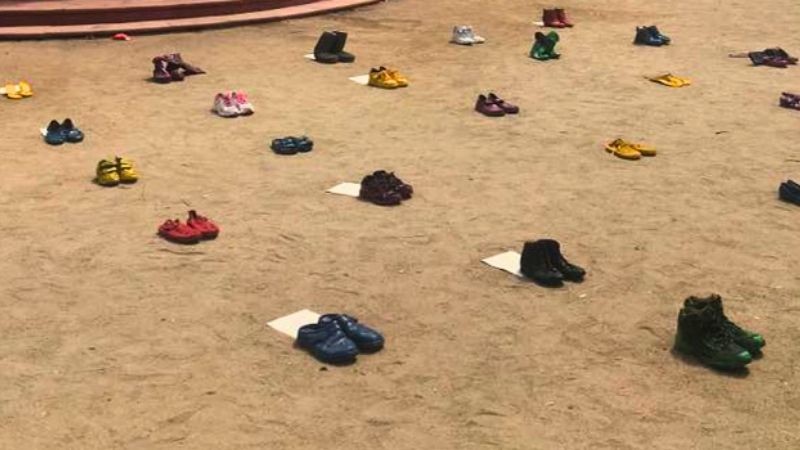 Colored shoe interactive installation each one with fragments of letters from concentration camp inmates