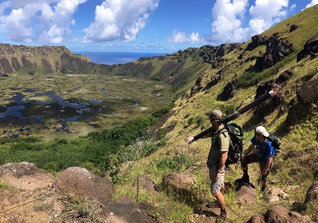 Nicholas Balascio and James Van Hook admiring Rano Kau while hiking out with one of many sediment cores. 
