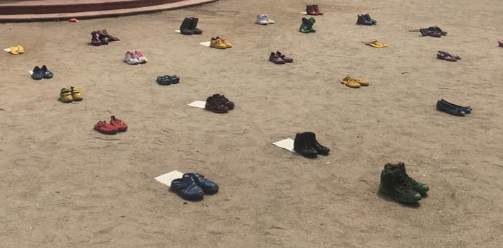 Colored shoe interactive installation each one with fragments of letters from concentration camp inmates Colored shoe interactive installation each one with fragments of letters from concentration camp inmates