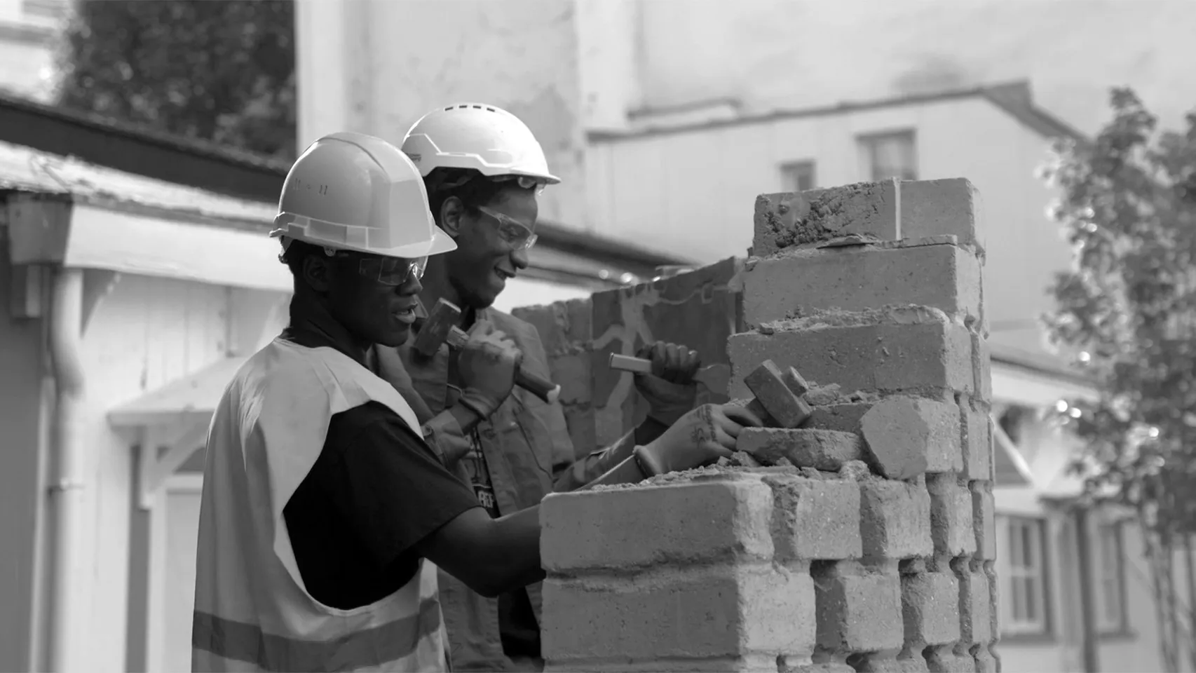 two men building a brick wall