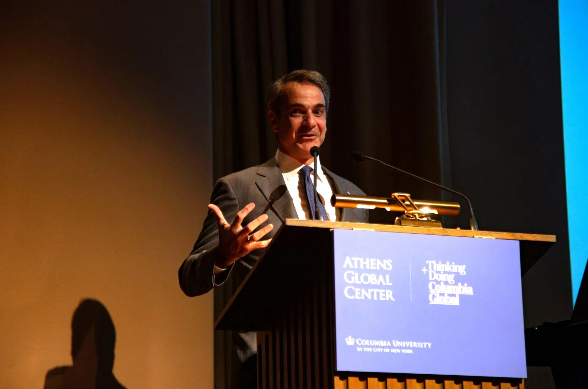 Prime Minister Kyriakos Mitsotakis  speaks from a podium.