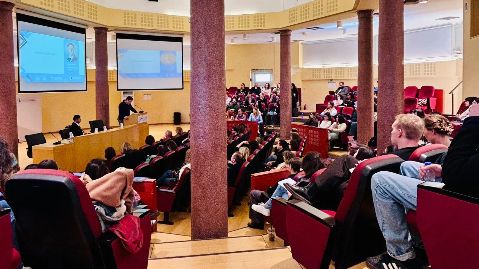Auditorium with students and speakers.
