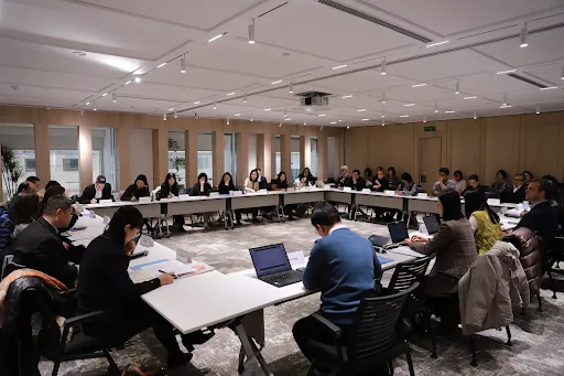 People sitting at a roundtable forum.