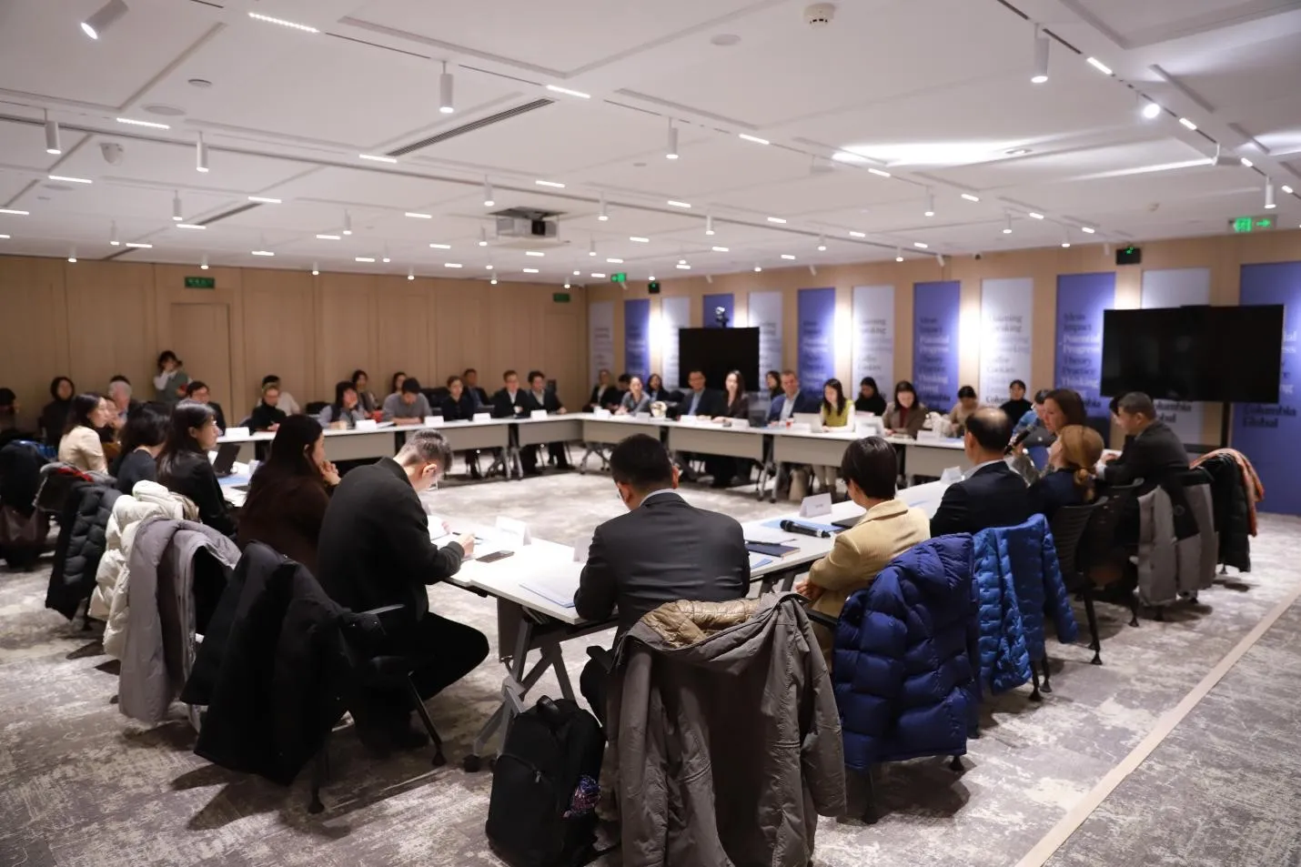 People sitting at desks in the new Beijing Center.