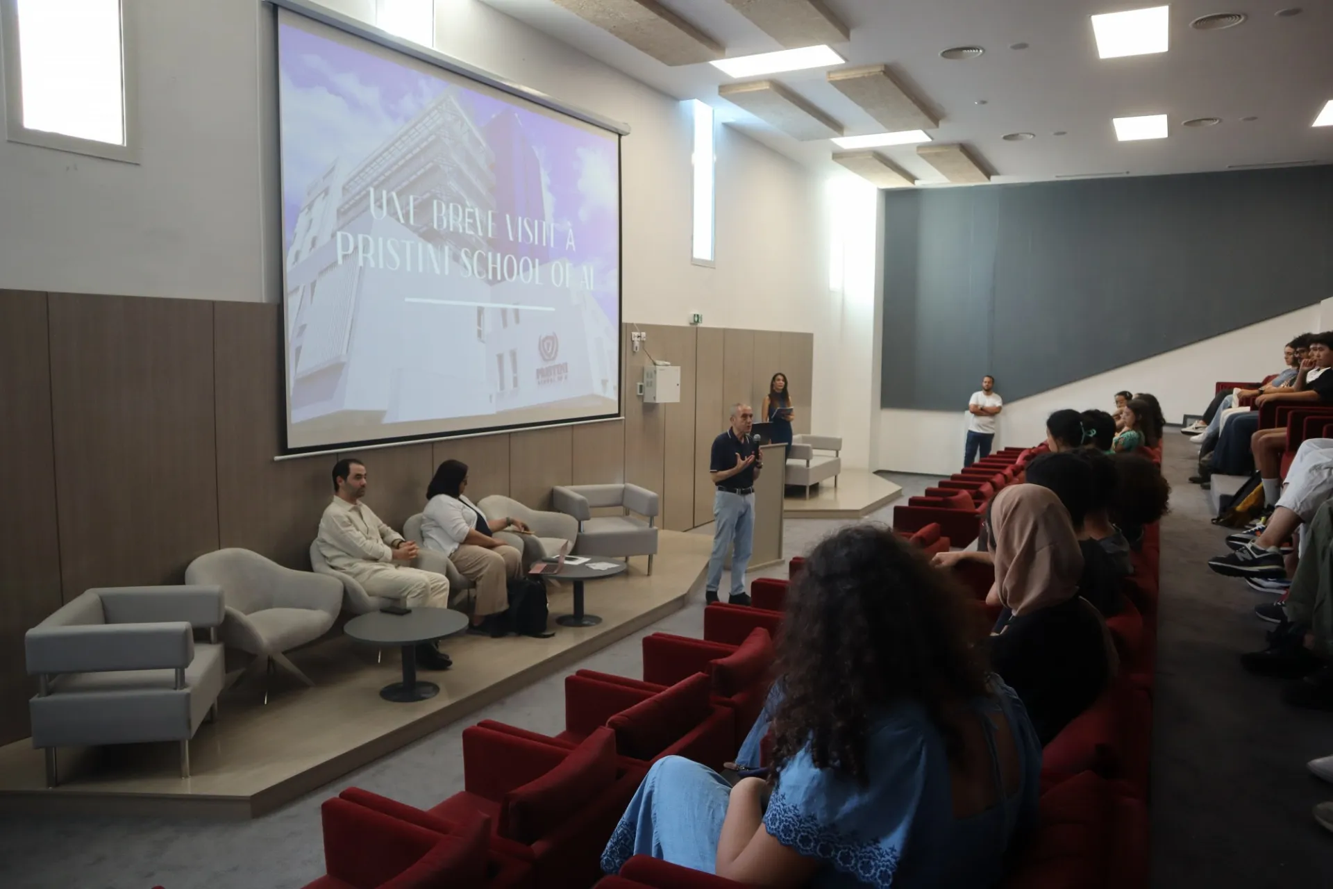 high school students sit in an auditorium
