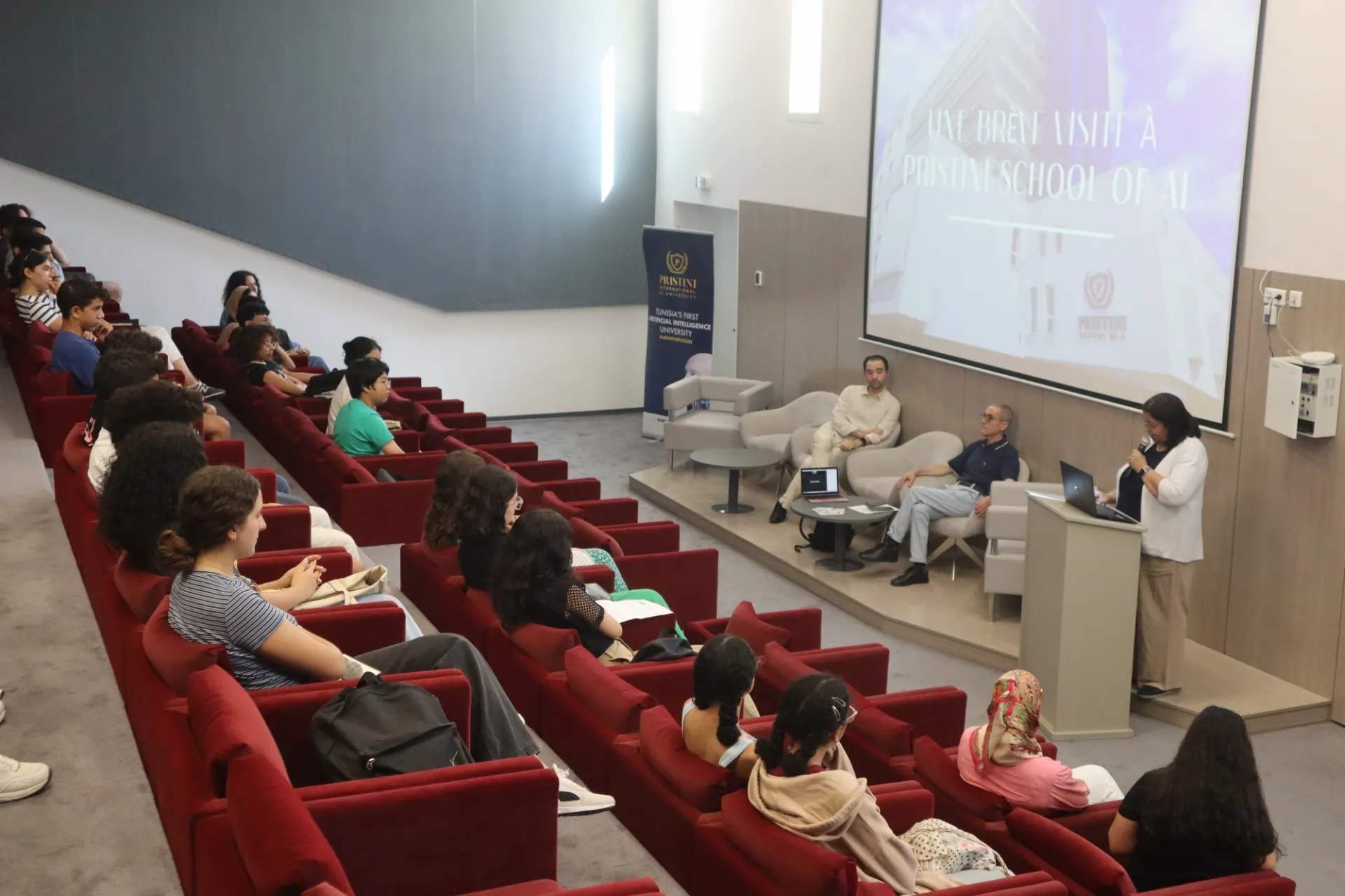 high school students sit in an auditorium