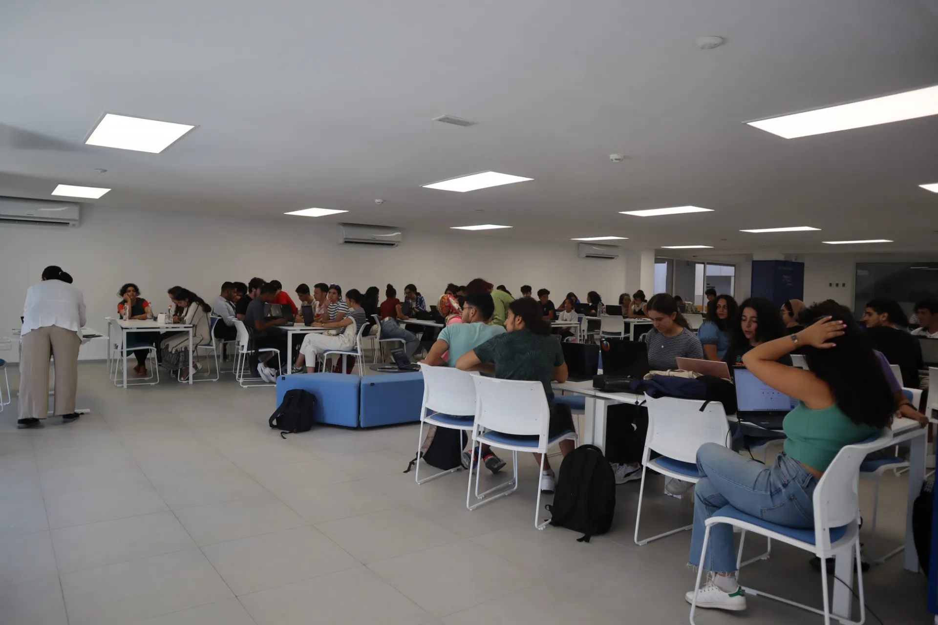 high school students sit at tables in a classroom