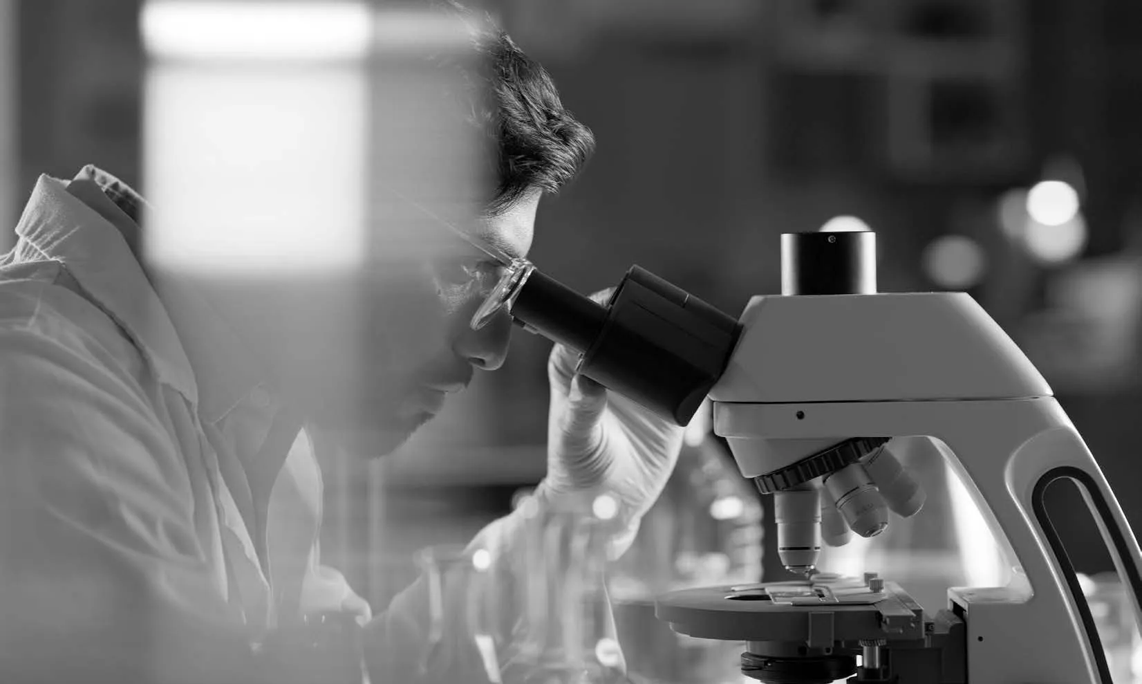 scientist looking into a microscope