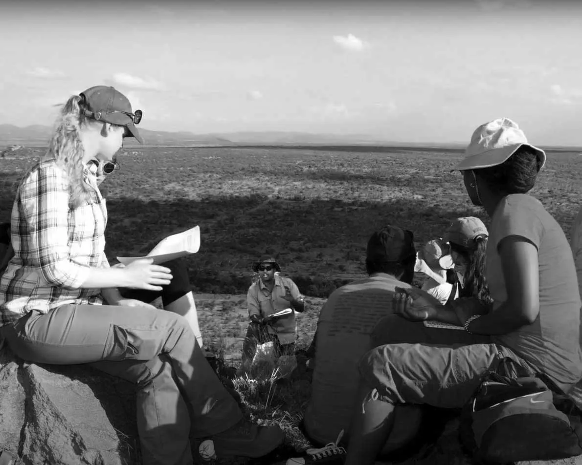 students with professor in the field