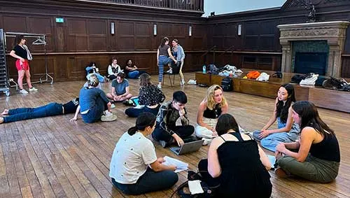 Student actors and translator working together in the Grande Salle