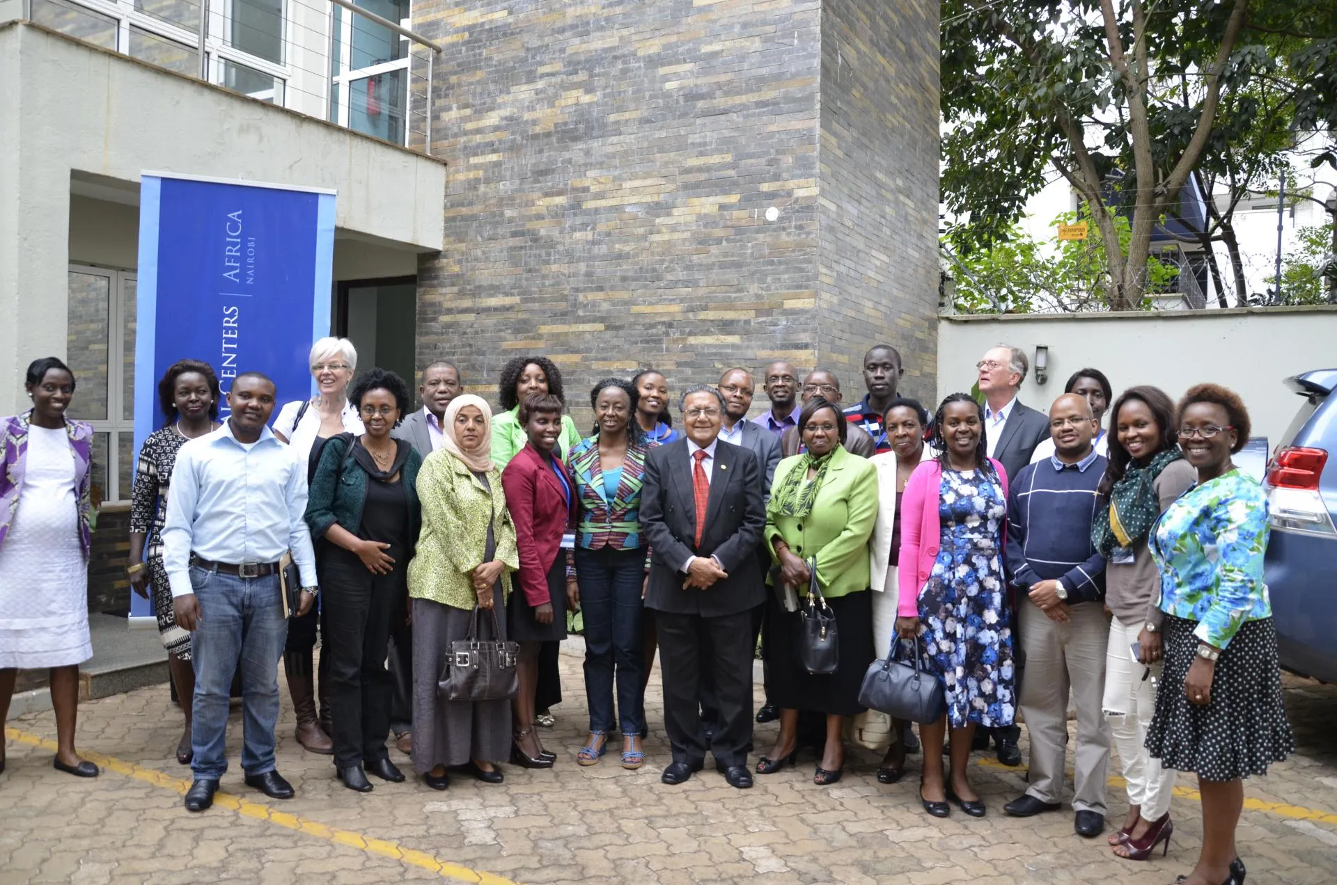 people standing outside of nairobi center after conference