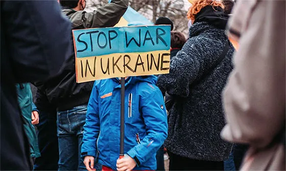 Boy holding protest sign (Pexels photo courtesy of Matti, A Kid Protesting against the War in Ukraine in Berlin, Feb. 22, 2022.)