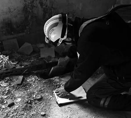 worker examining floor damage