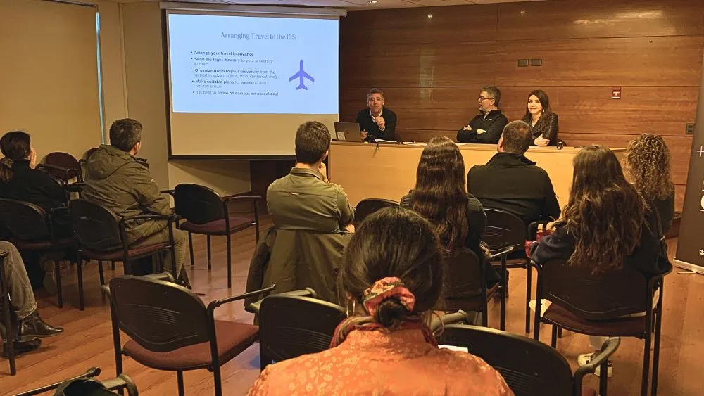 people at a table addressing an audience